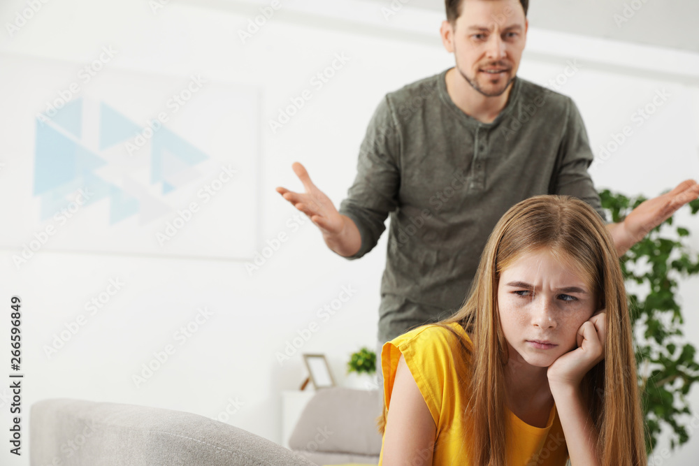 Fototapeta premium Father scolding his teenager daughter at home