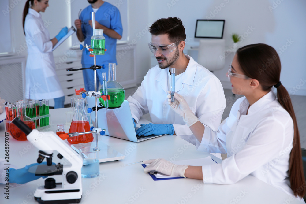 Medical students working in modern scientific laboratory Medical students working in modern scientific laboratory