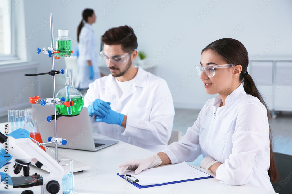 Medical students working in modern scientific laboratory Medical students working in modern scientific laboratory