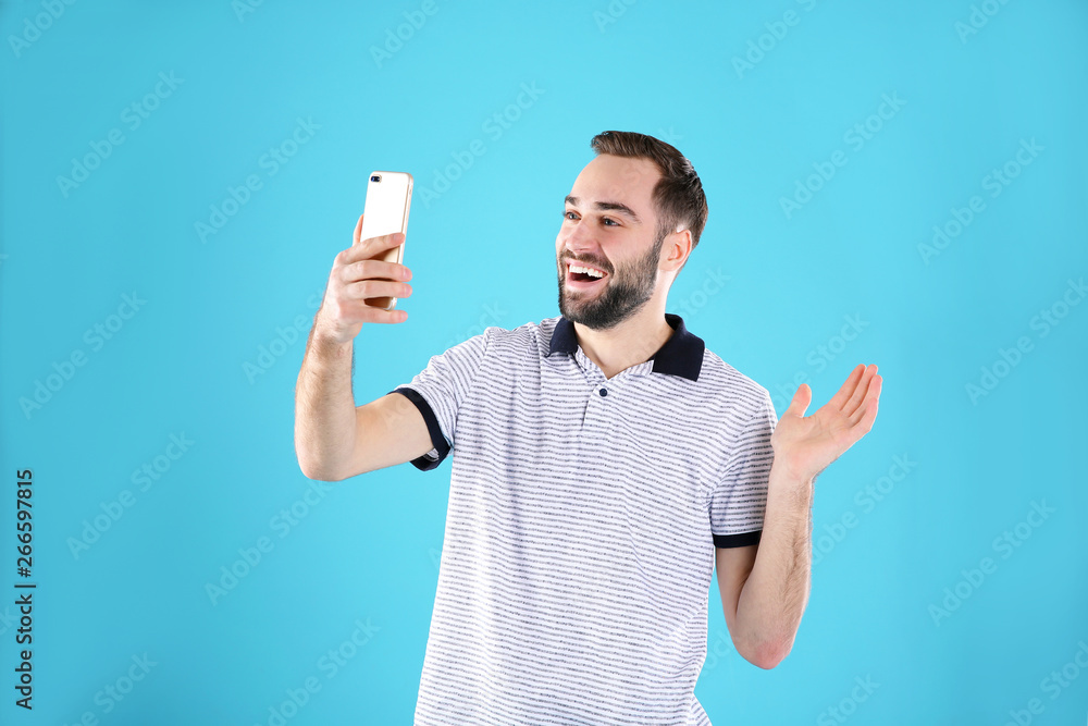Man using mobile phone for video chat on color background Man using mobile phone for video chat on color background