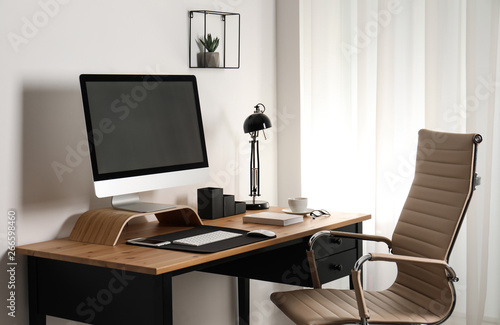 Stylish workplace interior with modern computer on table. Mockup for design © New Africa