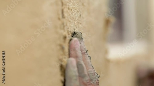 Close up hands builders insulate house from outside.