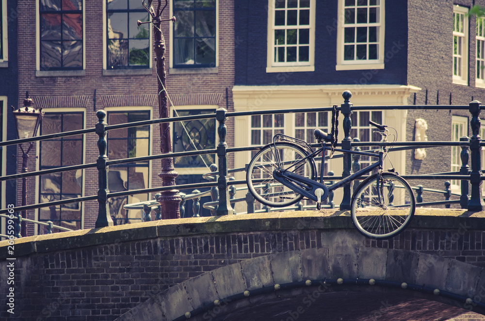 bicycle hanging on a bridge in Amsterdam