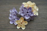 Purple and yellow origami kusudama flower on wooden background
