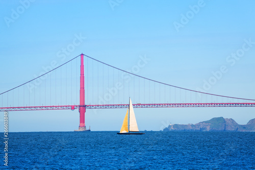 Sailboat passing under the Golden Gate Bridge, USA