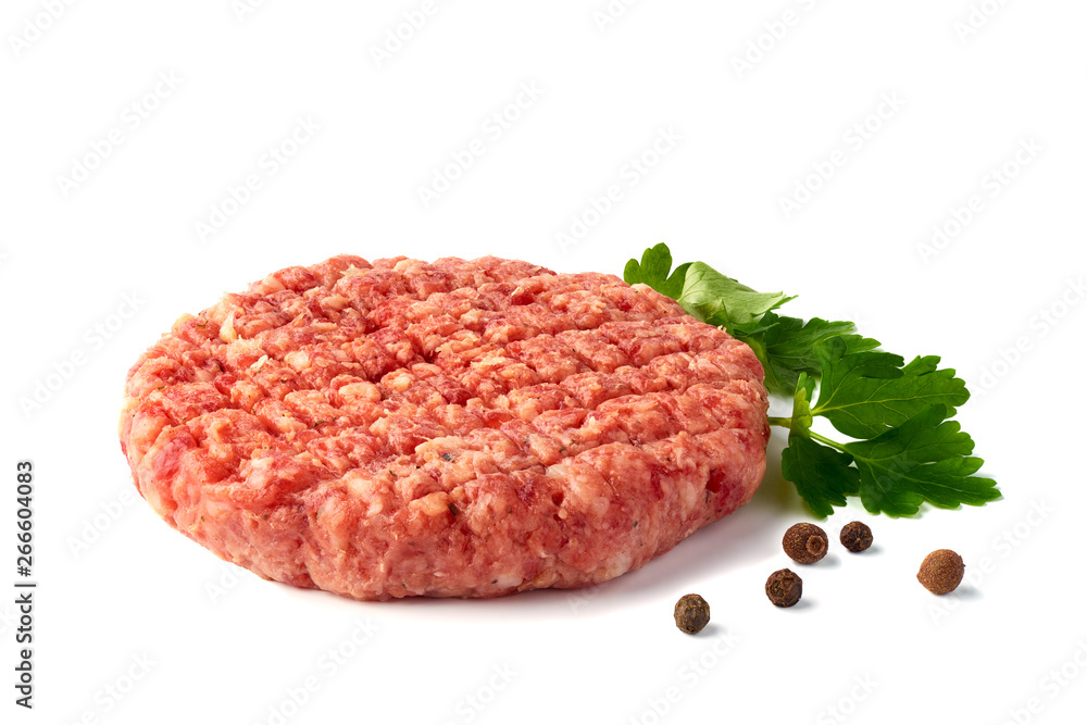 Raw beef patty with spices on white background Raw beef patty with spices on white background