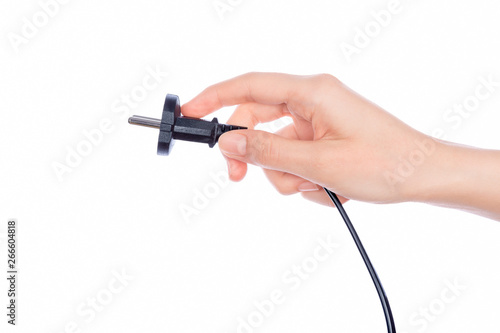 Woman hand holding black male wire plug on white