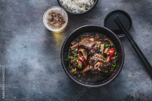 Fotografie Asian lamb stew in a pot, top view copy space