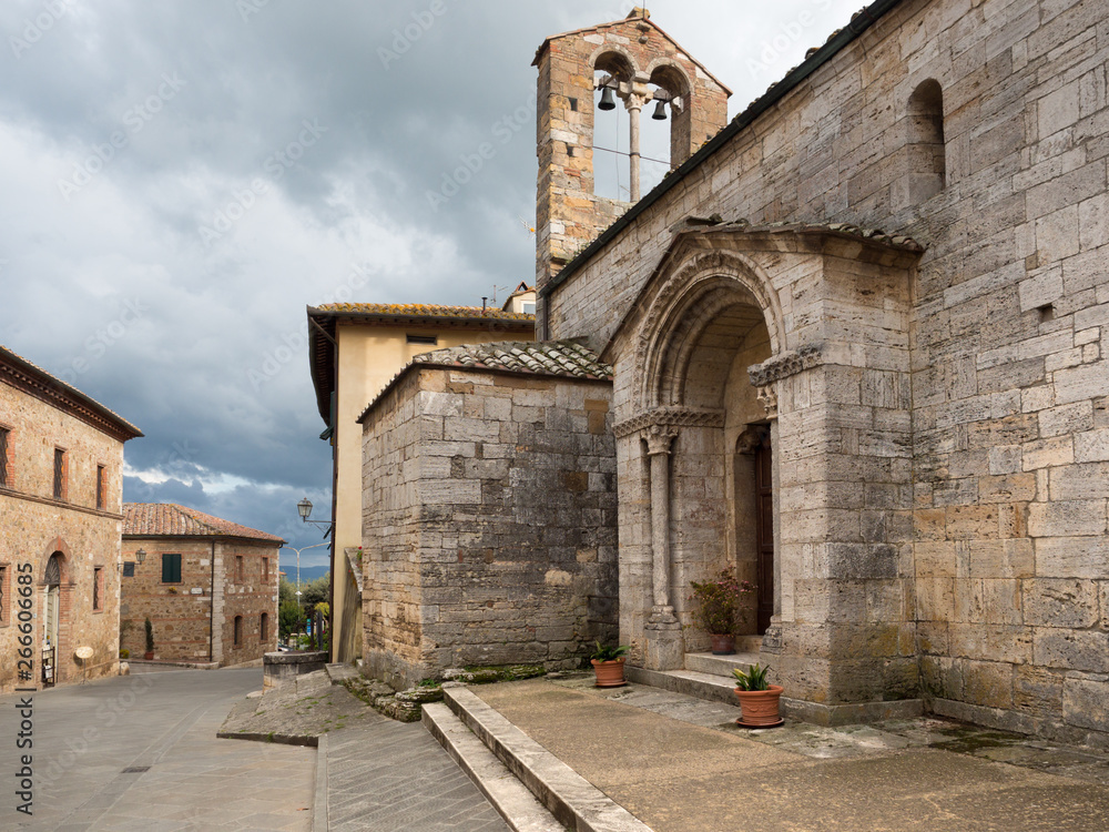 Ancient stone church in San Quirico D'Orcia, old medieval village in the Tuscan hills.