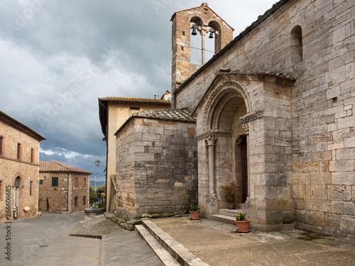 Ancient stone church in San Quirico D'Orcia, old medieval village in the Tuscan hills.