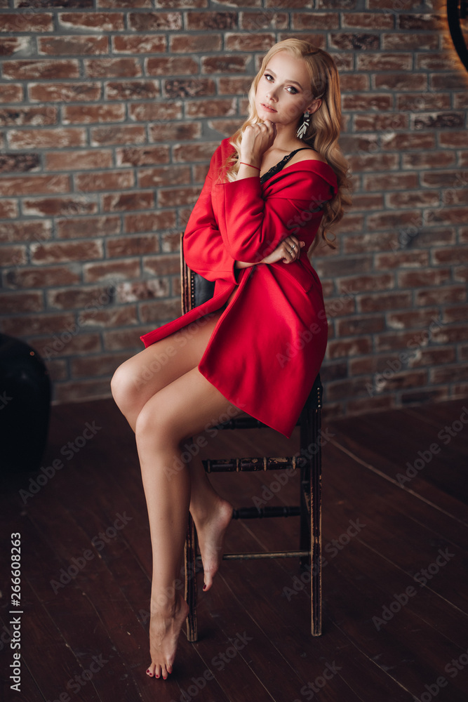 Blonde Foot Models Nude - Gorgeous blonde woman sitting on high chair and thoughtfully looking at  camera. Young pretty lady in