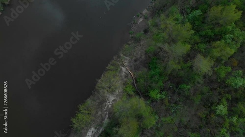 Sunny summer landscape with river.Green hills,fields and meadows.River Medvedica in Volgograd region,Russia.Sunrise.Quiet morning.Calm.Warm sunlight.Cloudless clear blue sky. 