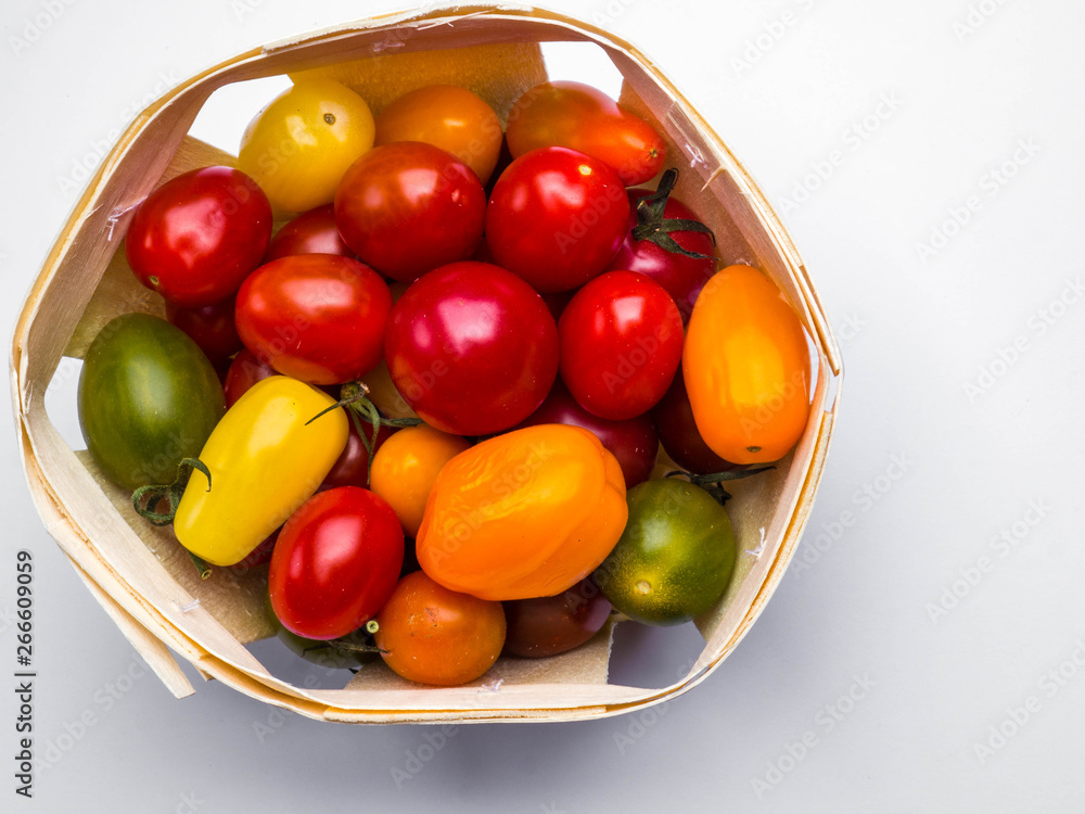 Fresh colorful cherry tomatoes on white background, raw food and vegetable concept Fresh colorful cherry tomatoes on white background, raw food and vegetable concept