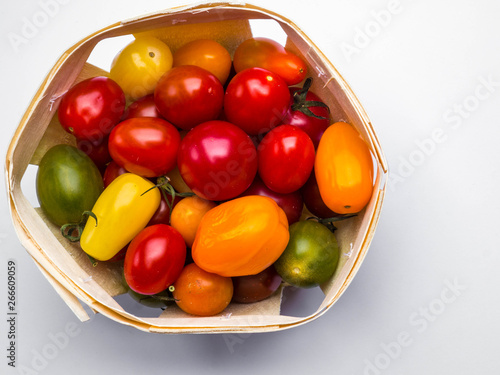 Fresh colorful cherry tomatoes on white background  raw food and vegetable concept