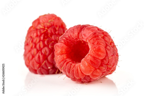 Group of two whole picked fresh red raspberry isolated on white background