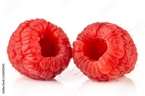 Closeup of two whole fresh red raspberry isolated on white background
