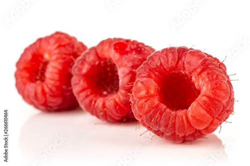 Group of three whole fresh red raspberry in row isolated on white background