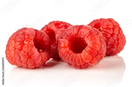 Group of four whole fresh red raspberry isolated on white background