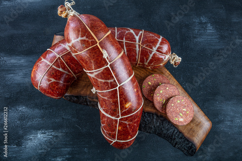 Traditional Hungarian speciality sliced sausage salami on wooden board. Hungarian sausage ( Macar Sucuk). photo