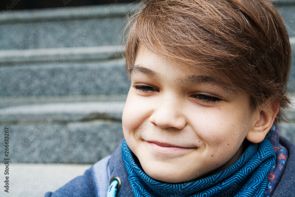 Portrait of a smiling teenager outdoors on blurred background, closeup Portrait of a smiling teenager outdoors on blurred background, closeup