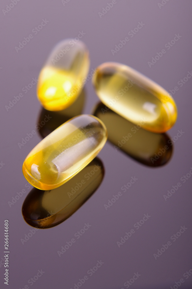 Macro close up of capsules of Omega 3 fatty acids for well-being Macro close up of capsules of Omega 3 fatty acids for well-being
