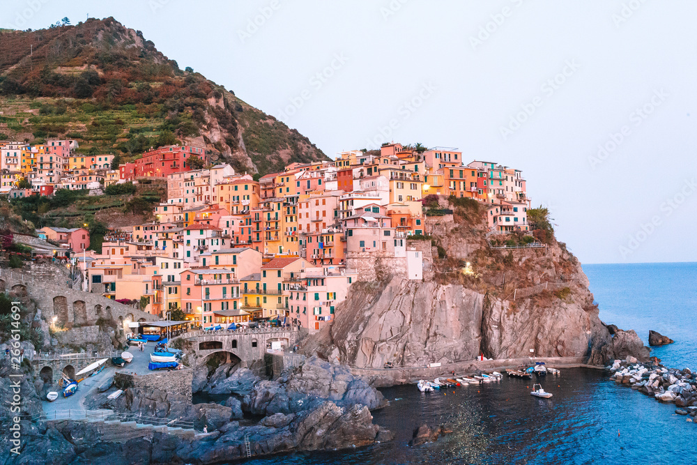 Stunning view of the beautiful and cozy village of Manarola in the Cinque Terre Reserve at sunset. Liguria region of Italy.
