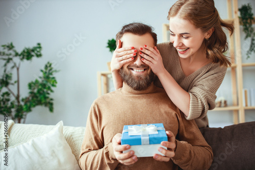 Happy married couple man and woman give a gift for holiday      . photo