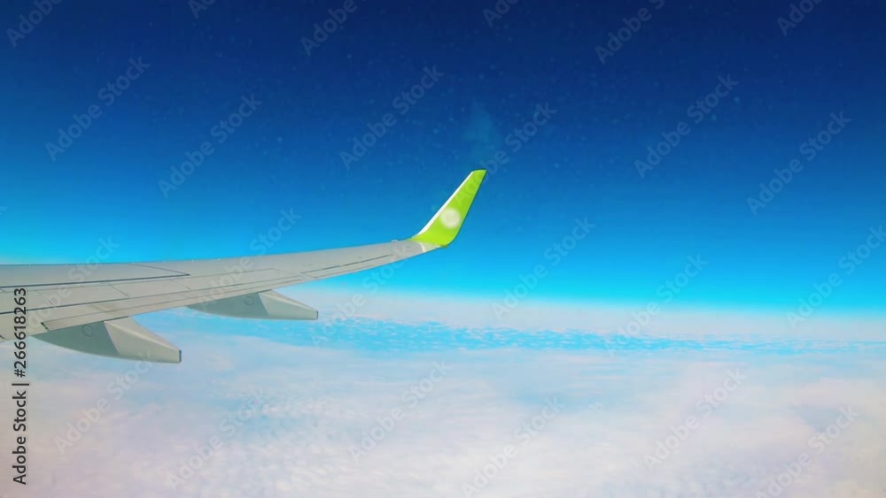 A plane with wings flying in the sky in clouds. A plane with wings flying in the sky in clouds.