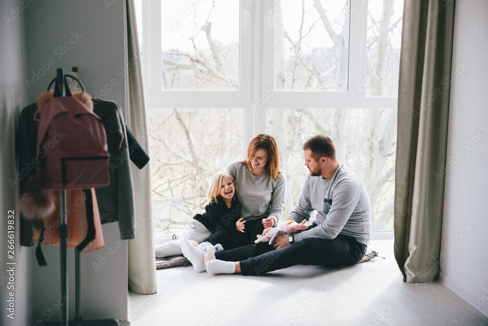 mom and dad are having fun with a child