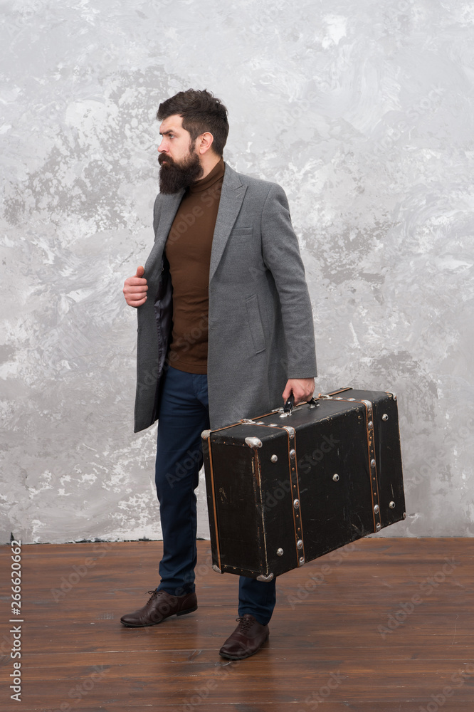 trendy man with travel suitcase. Vintage trip bagage. Modern life. Male  fashion model. Mature businessman with beard. Travelling fot business.  Casual style. Brutal bearded hipster in denim wear Stock Photo | Adobe