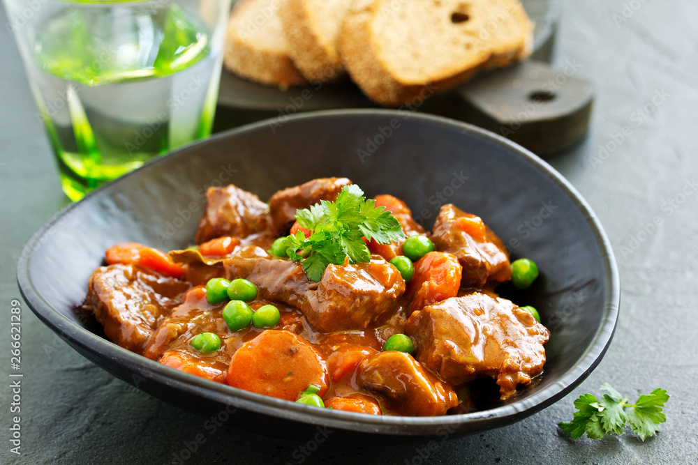 Beef stew in Burgundy. With carrots, onions, peas and champignons in wine. View from above. Beef stew in Burgundy. With carrots, onions, peas and champignons in wine. View from above.