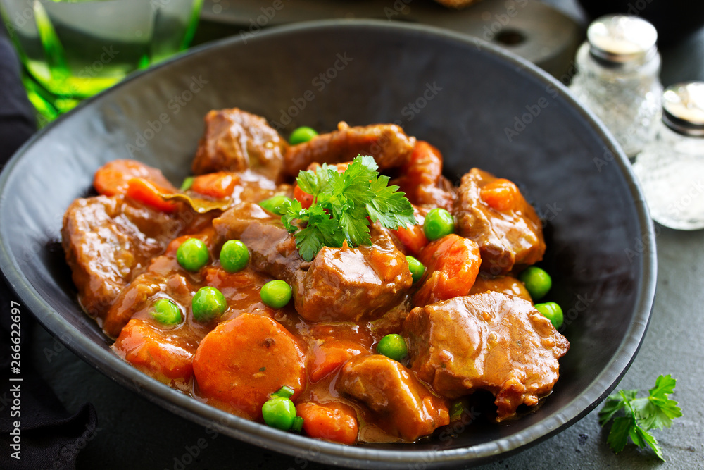 Beef stew in Burgundy. With carrots, onions, peas and champignons in wine. View from above. Beef stew in Burgundy. With carrots, onions, peas and champignons in wine. View from above.