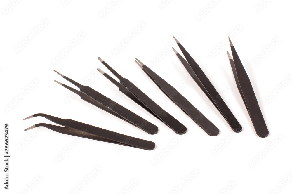 Set of antistatic tweezers isolated on the white background Set of antistatic tweezers isolated on the white background