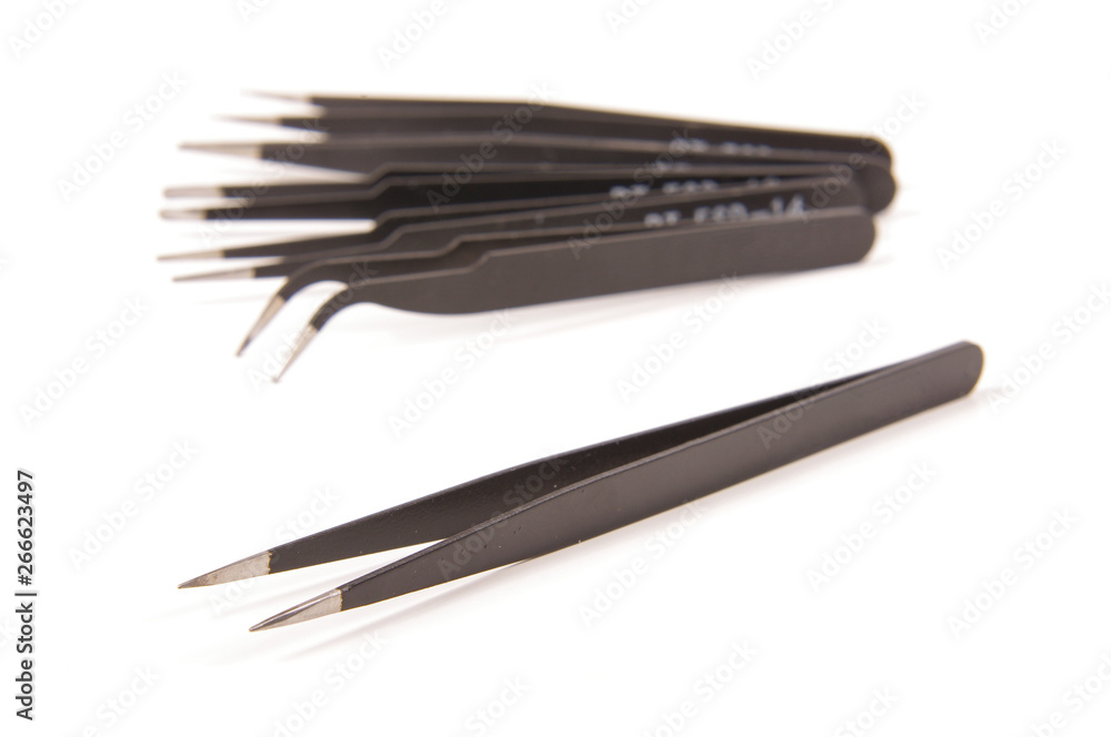 Set of antistatic tweezers isolated on the white background Set of antistatic tweezers isolated on the white background