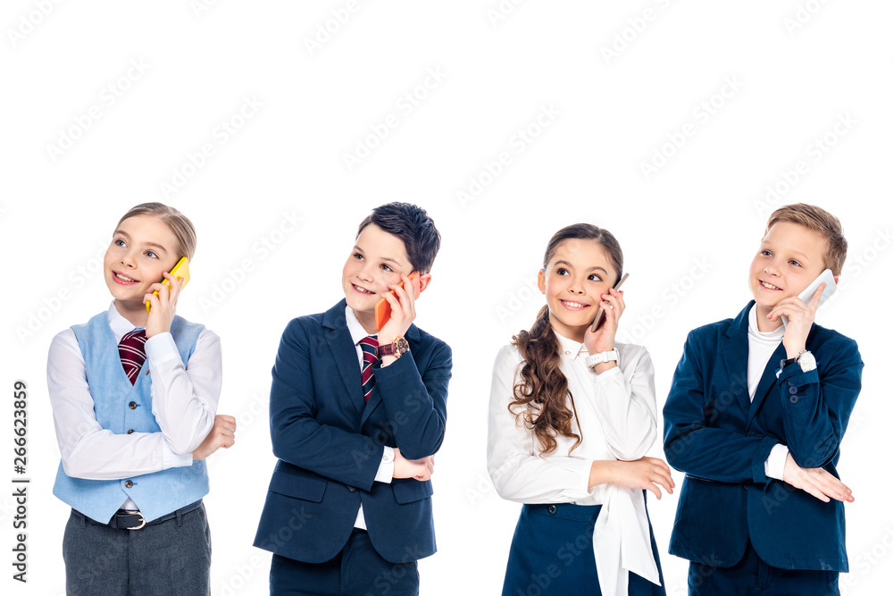 happy schoolchildren pretending to be businesspeople talking on smartphones Isolated On White happy schoolchildren pretending to be businesspeople talking on smartphones Isolated On White