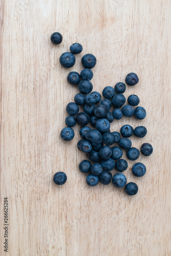 Blueberries on a wooden background. Blue berries, healthy food on dark table mockup, berry for smoothie on vintage rustic country board, copy space for text