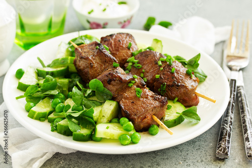 Beef kebab with cucumber and green pea salad. Healthy food.