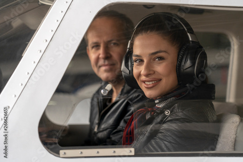 Smiling Female Pilot and Flight Instructor in an Aircraft Cockpit