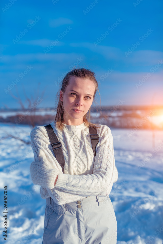 A beautiful woman, girl in warm sweater overalls winter fresh air. Background snow drifts. The concept of rest resort winter. Emotions relaxation, comfort nature, fresh, frosty winter air. A beautiful woman, girl in warm sweater overalls winter fresh air. Background snow drifts. The concept of rest resort winter. Emotions relaxation, comfort nature, fresh, frosty winter air.