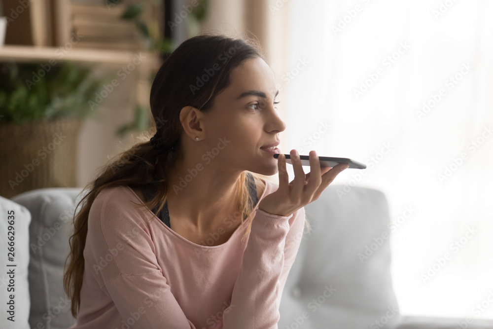 Woman holding smartphone using virtual assistant or talk on speakerphone Woman holding smartphone using virtual assistant or talk on speakerphone