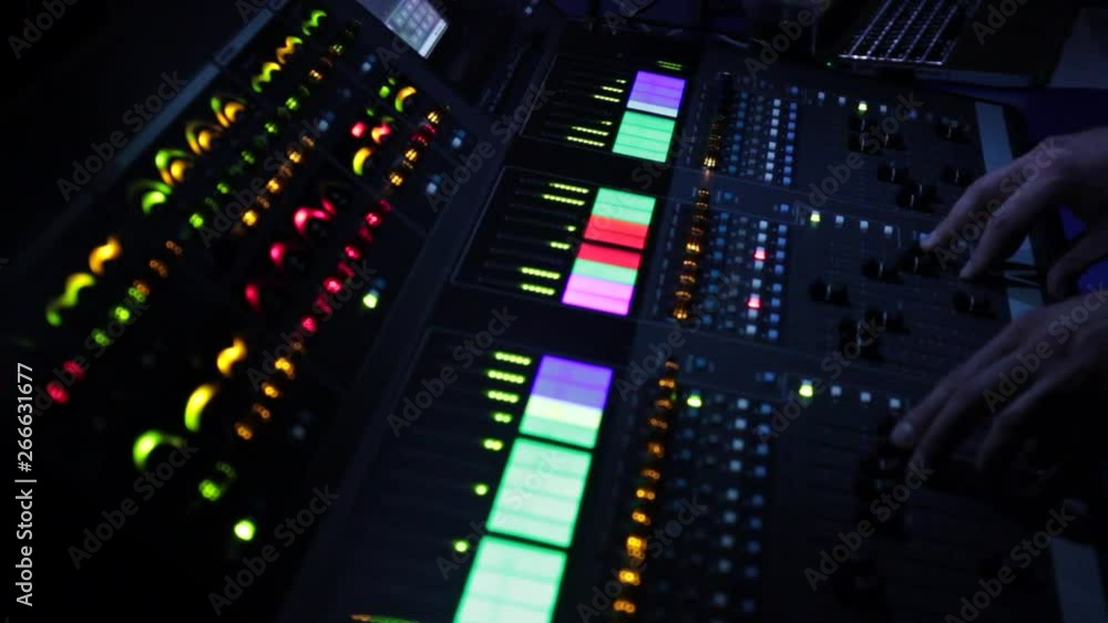 Audio mixer at the concert controls the music Audio mixer at the concert controls the music