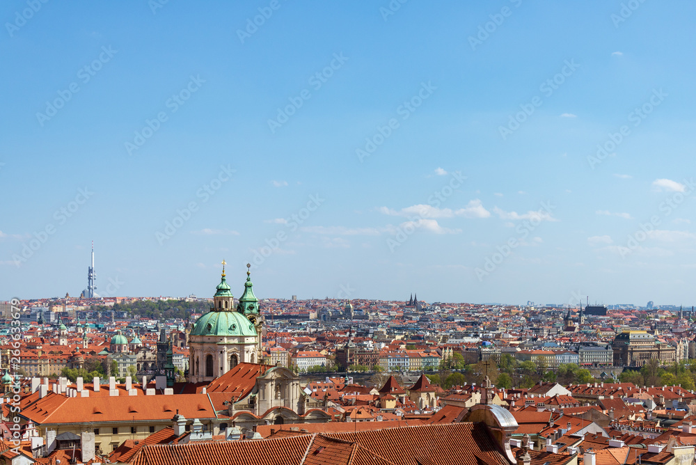 Outdoor sunny aerial top panoramic view of rooftop old town Prague skyline from observation deck near Prague Castle and staircase and barckground of farther Towerpark Praha in Prague, Czech Republic.