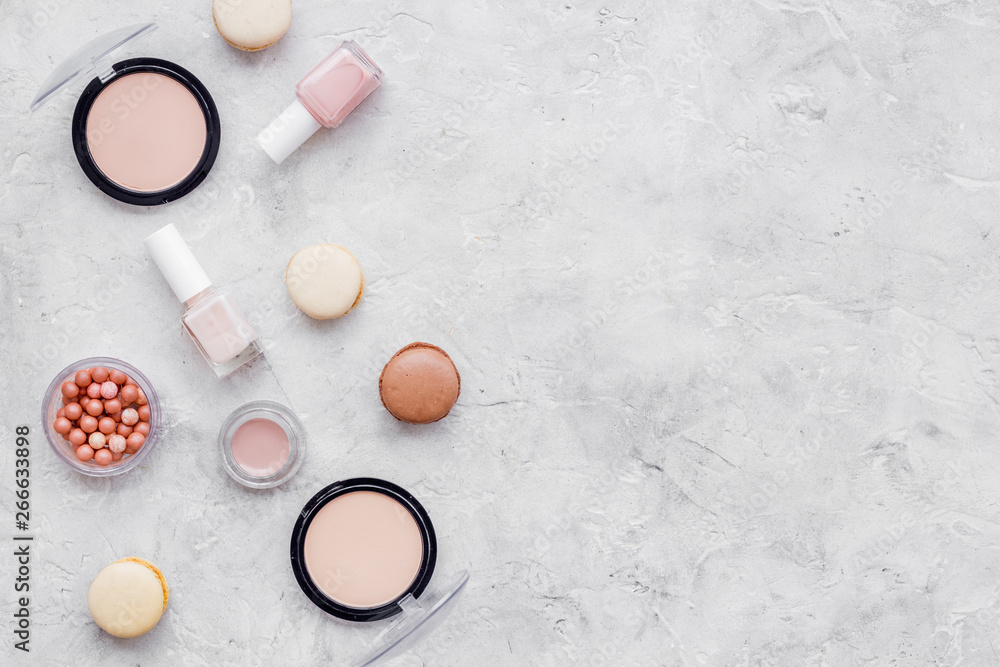 decorative cosmetics for make-up with macaroon cookies on gray stone tabletop background mockup decorative cosmetics for make-up with macaroon cookies on gray stone tabletop background mockup