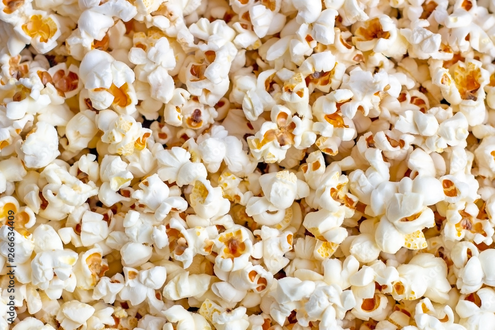 White and yellow fresh salted popcorn texture background. Close up top view food pattern photography White and yellow fresh salted popcorn texture background. Close up top view food pattern photography