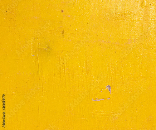 Old grunge cracked vintage bright yellow concrete and cement mold texture wall or floor background with weathered paint and scratches
