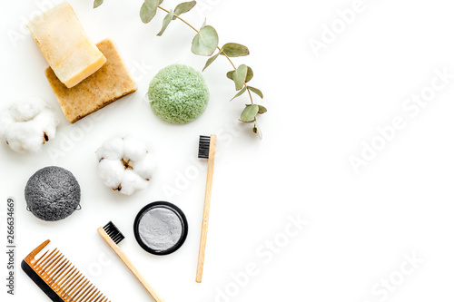 Eco materials concept with bamboo tooth brush and toothpaste with bamboo carbon on white background top view copy space