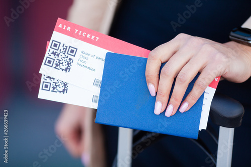 Travel. Closeup of girl holding passports and boarding pass at airport