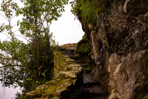 Rock stair curved Incan trail at Machu Picchu
