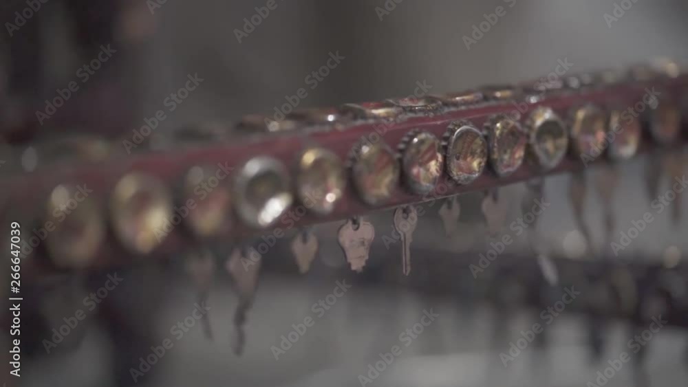 Close-up roll up shot of an art sculpture made of metal keys and metal bottle caps along with a blurry background - bokeh. Close-up roll up shot of an art sculpture made of metal keys and metal bottle caps along with a blurry background - bokeh.