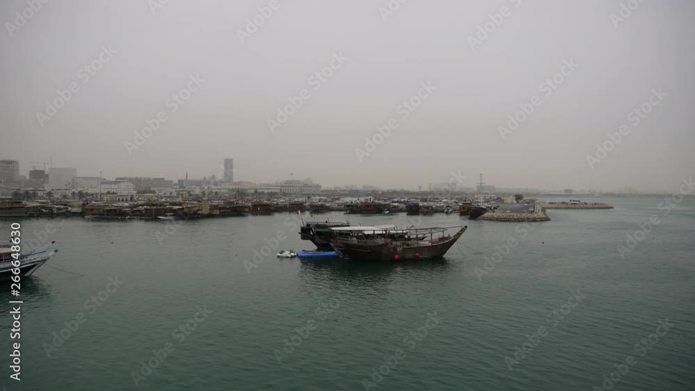 Skyline of beautiful Doha - traditional Dhow boat mooring in foreground - Doha, Qatar Skyline of beautiful Doha - traditional Dhow boat mooring in foreground - Doha, Qatar